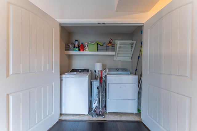 laundry area featuring laundry area, hardwood / wood-style flooring, and washer and clothes dryer