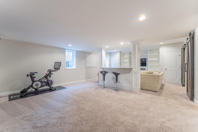 exercise area featuring light carpet, baseboards, and recessed lighting