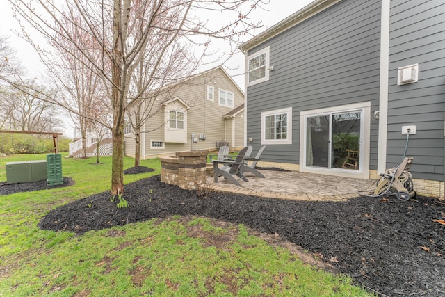 exterior space featuring a patio area and an outdoor fire pit
