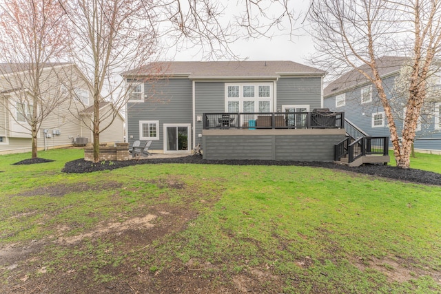 back of property featuring central AC unit, a deck, a yard, a patio area, and stairway