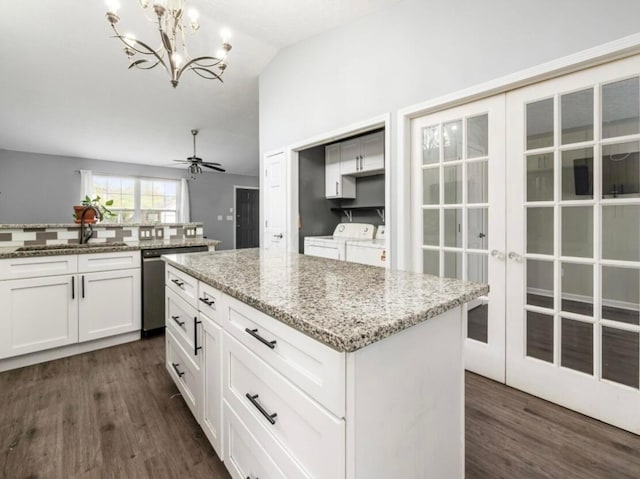 kitchen with washing machine and clothes dryer, dark wood-style flooring, lofted ceiling, and dishwasher