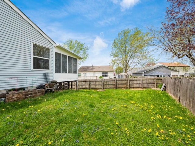 view of yard with a fenced backyard and a sunroom
