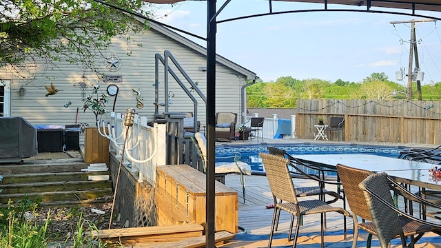 exterior space featuring a grill, fence, and a fenced in pool