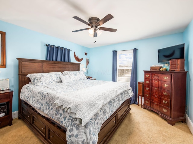 bedroom featuring ceiling fan, light carpet, and baseboards