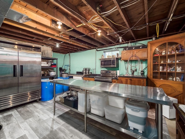 basement with light wood-style floors and stainless steel built in refrigerator