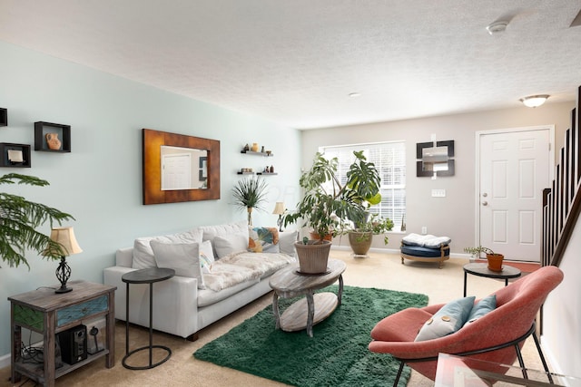 living area with carpet, stairway, and a textured ceiling