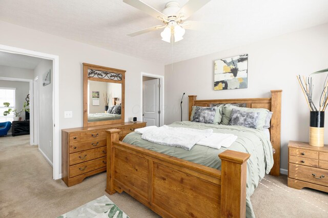 bedroom featuring baseboards, light carpet, and ceiling fan