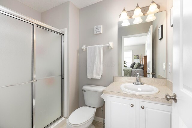 bathroom featuring a stall shower, toilet, ensuite bathroom, and vanity