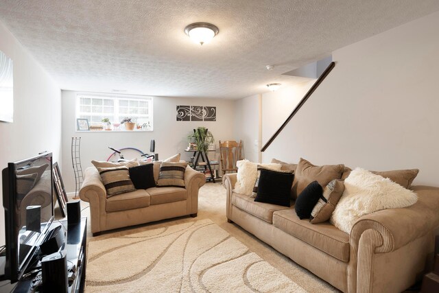 living room featuring a textured ceiling and carpet floors