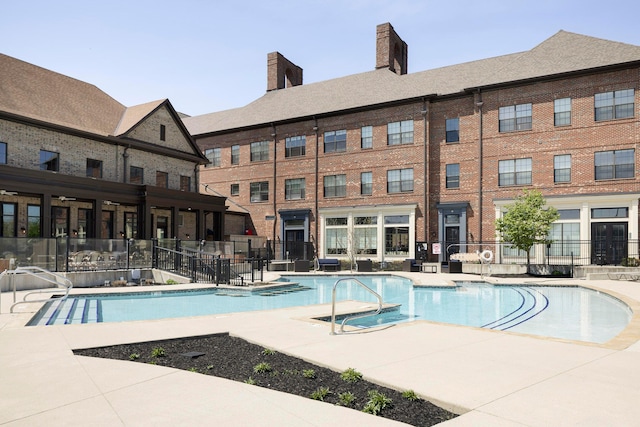 community pool featuring a patio area and fence
