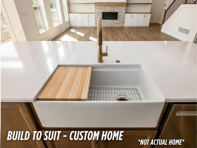 1736 Harvey Ln, Grove City, OH 43123 - details featuring wood finished floors, a sink, dishwasher, white cabinets, and visible vents