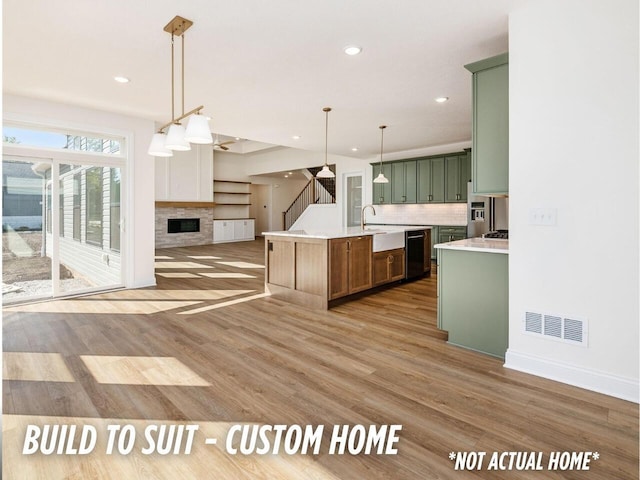 1736 Harvey Ln, Grove City, OH 43123 - kitchen featuring green cabinetry, recessed lighting, black dishwasher, light countertops, and a fireplace