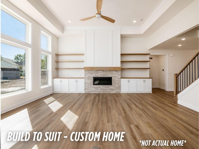 1736 Harvey Ln, Grove City, OH 43123 - unfurnished living room with a ceiling fan, ornamental molding, light wood-type flooring, baseboards, and stairs