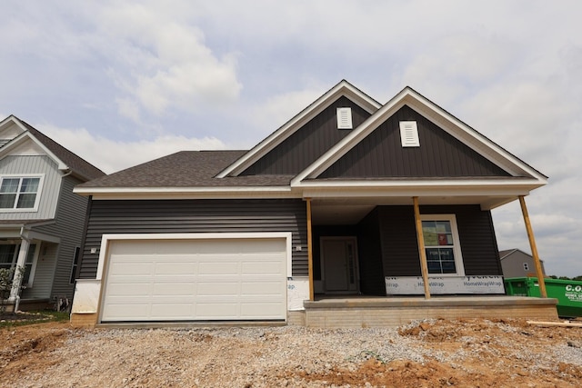 craftsman inspired home with covered porch, an attached garage, and driveway