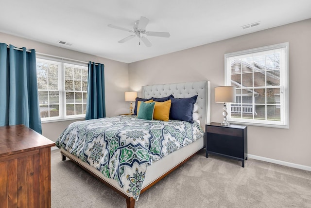 bedroom with carpet flooring, baseboards, multiple windows, and visible vents