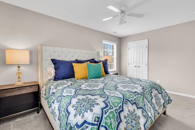 carpeted bedroom with a closet, visible vents, baseboards, and a ceiling fan