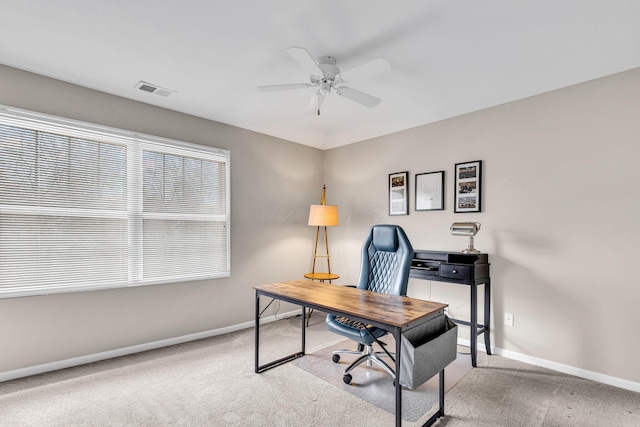 carpeted office featuring visible vents, baseboards, and ceiling fan