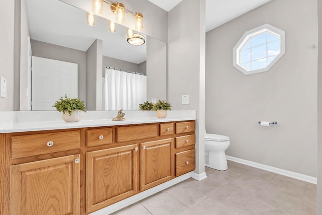 full bathroom featuring toilet, vanity, baseboards, and tile patterned flooring