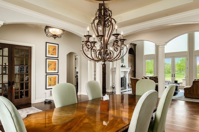 10577 Wellington Blvd, Powell, OH 43065 - dining area with french doors, arched walkways, dark wood-style flooring, a chandelier, and crown molding