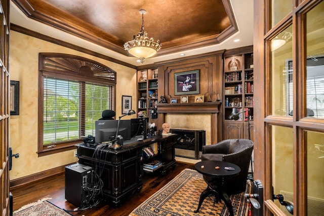 10577 Wellington Blvd, Powell, OH 43065 - home office featuring a tray ceiling, dark wood-style flooring, ornamental molding, a high end fireplace, and baseboards