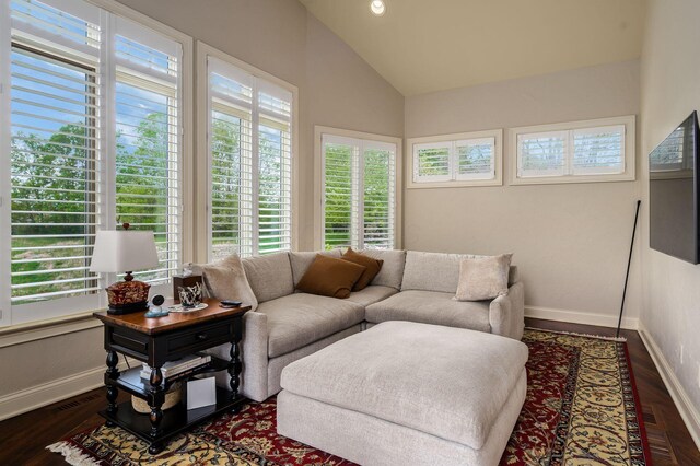 10577 Wellington Blvd, Powell, OH 43065 - living room featuring healthy amount of natural light, vaulted ceiling, baseboards, and dark wood-type flooring