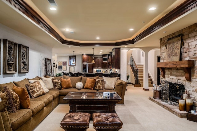 10577 Wellington Blvd, Powell, OH 43065 - living area with arched walkways, crown molding, a tray ceiling, light carpet, and recessed lighting