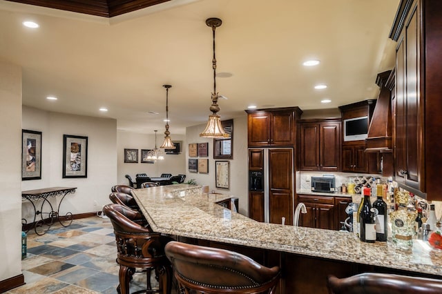 10577 Wellington Blvd, Powell, OH 43065 - kitchen featuring paneled refrigerator, baseboards, dark brown cabinets, a kitchen bar, and recessed lighting