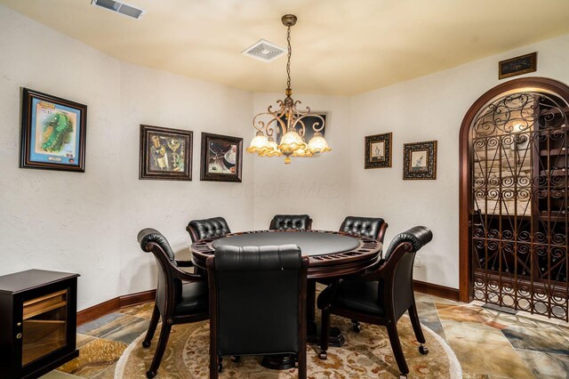 10577 Wellington Blvd, Powell, OH 43065 - dining area with baseboards, a chandelier, and stone finish floors