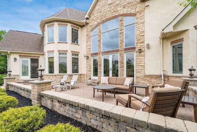 10577 Wellington Blvd, Powell, OH 43065 - back of property featuring a patio, stone siding, an outdoor living space, and stucco siding