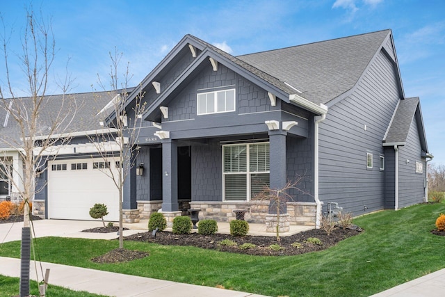 8688 Eliot Dr, Plain City, OH 43064 - craftsman-style house with a front yard, a shingled roof, driveway, and an attached garage