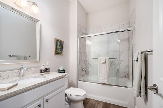 8688 Eliot Dr, Plain City, OH 43064 - bathroom featuring toilet, enclosed tub / shower combo, vanity, and wood finished floors