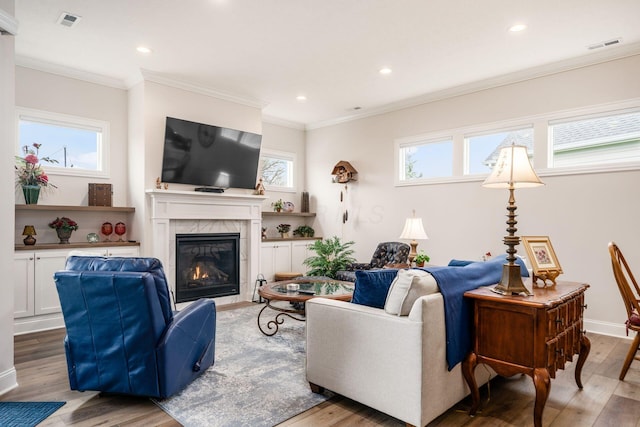 8688 Eliot Dr, Plain City, OH 43064 - living area with recessed lighting, visible vents, a premium fireplace, and wood finished floors
