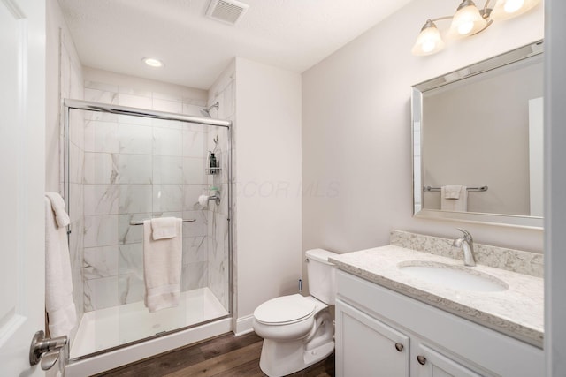 8688 Eliot Dr, Plain City, OH 43064 - bathroom with vanity, toilet, a shower stall, visible vents, and wood finished floors