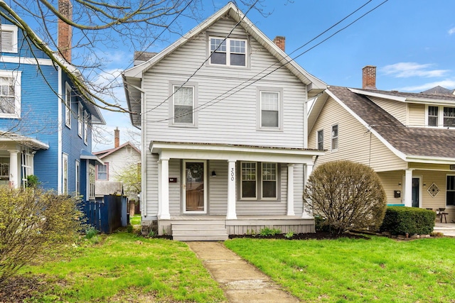 300 N Franklin St, Delaware, OH 43015 - traditional style home featuring a porch, a chimney, and a front yard