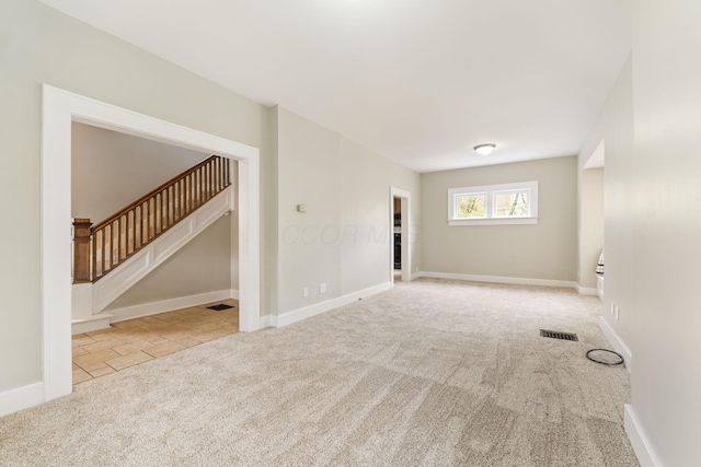 300 N Franklin St, Delaware, OH 43015 - spare room with stairs, carpet flooring, visible vents, and baseboards