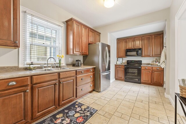 300 N Franklin St, Delaware, OH 43015 - kitchen with baseboards, a sink, brown cabinets, and black appliances