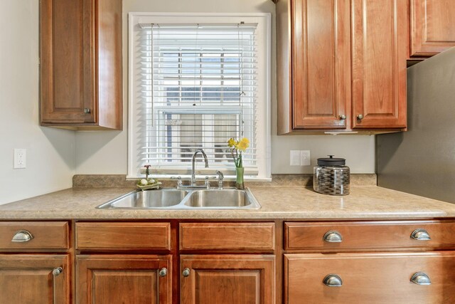 300 N Franklin St, Delaware, OH 43015 - kitchen featuring light countertops, a sink, and brown cabinetry