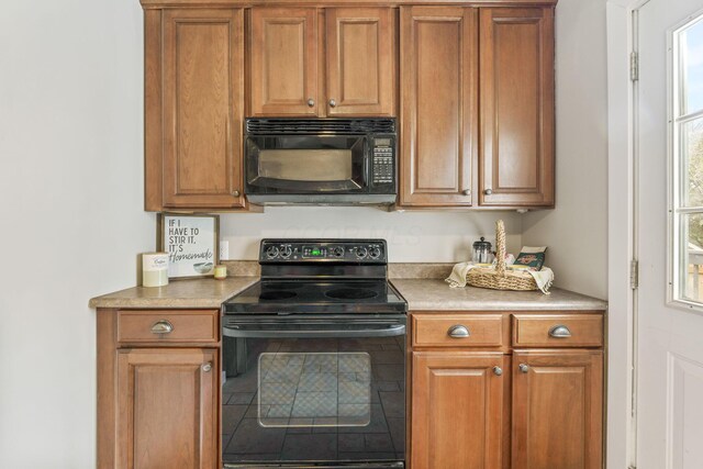300 N Franklin St, Delaware, OH 43015 - kitchen with brown cabinetry, light countertops, and black appliances