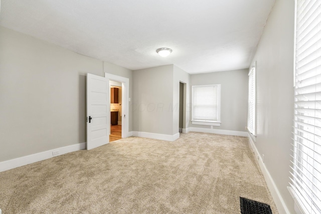300 N Franklin St, Delaware, OH 43015 - unfurnished bedroom featuring carpet, visible vents, and baseboards