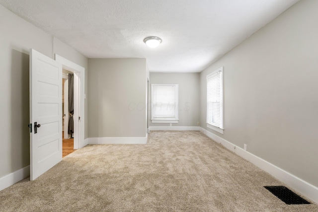 300 N Franklin St, Delaware, OH 43015 - carpeted empty room with visible vents, baseboards, and a textured ceiling