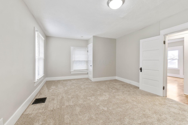 300 N Franklin St, Delaware, OH 43015 - carpeted spare room featuring visible vents, a wealth of natural light, and baseboards