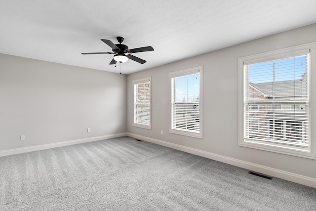 3697 Echo Pl, Powell, OH 43065 - unfurnished room featuring a healthy amount of sunlight, carpet floors, ceiling fan, baseboards, and visible vents