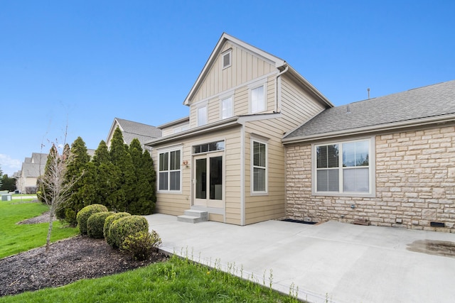 3697 Echo Pl, Powell, OH 43065 - back of property with a patio area, entry steps, board and batten siding, and stone siding