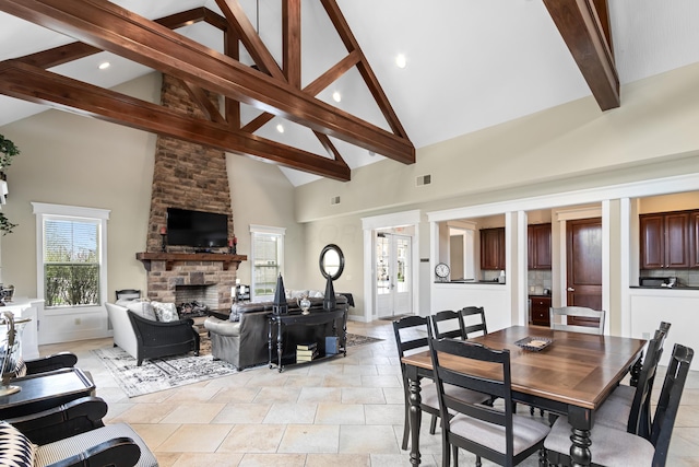 3697 Echo Pl, Powell, OH 43065 - dining area with visible vents, high vaulted ceiling, beamed ceiling, and a stone fireplace