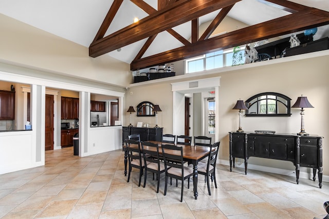 3697 Echo Pl, Powell, OH 43065 - dining space featuring stone finish floor, beamed ceiling, visible vents, baseboards, and high vaulted ceiling