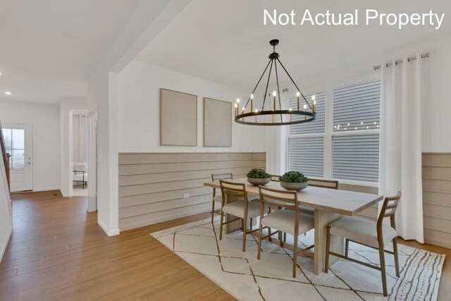 dining area with a chandelier, light wood-style flooring, baseboards, and recessed lighting