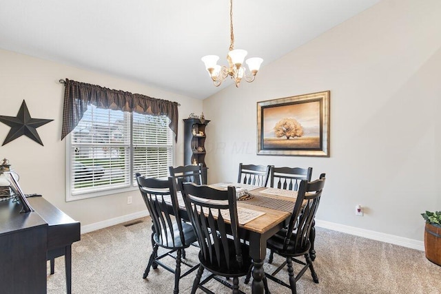 dining room featuring light colored carpet, baseboards, and an inviting chandelier