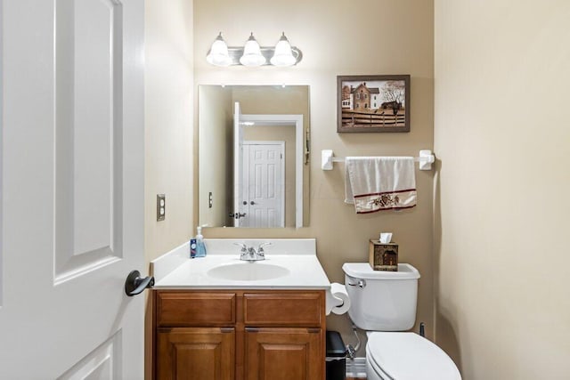 bathroom with toilet and vanity