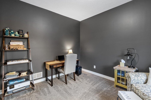 home office with visible vents, baseboards, and carpet flooring