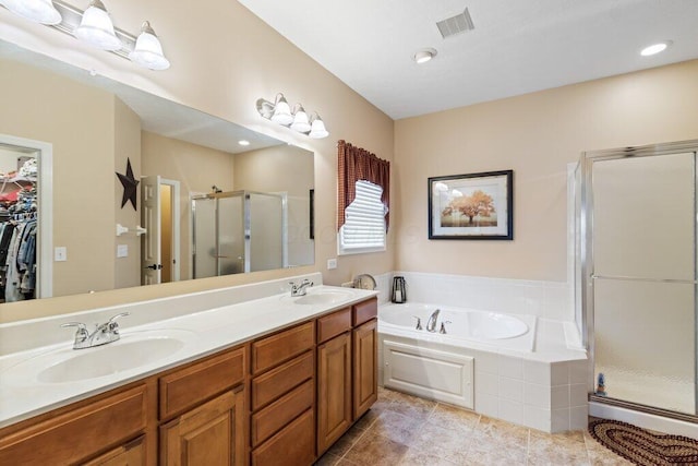 bathroom featuring a bath, a stall shower, double vanity, and a sink